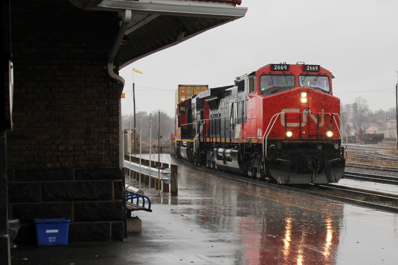 12:15 on a very wet Sunday, train 148 an eastbound intermodal picks up speed as it drives on through the rain!