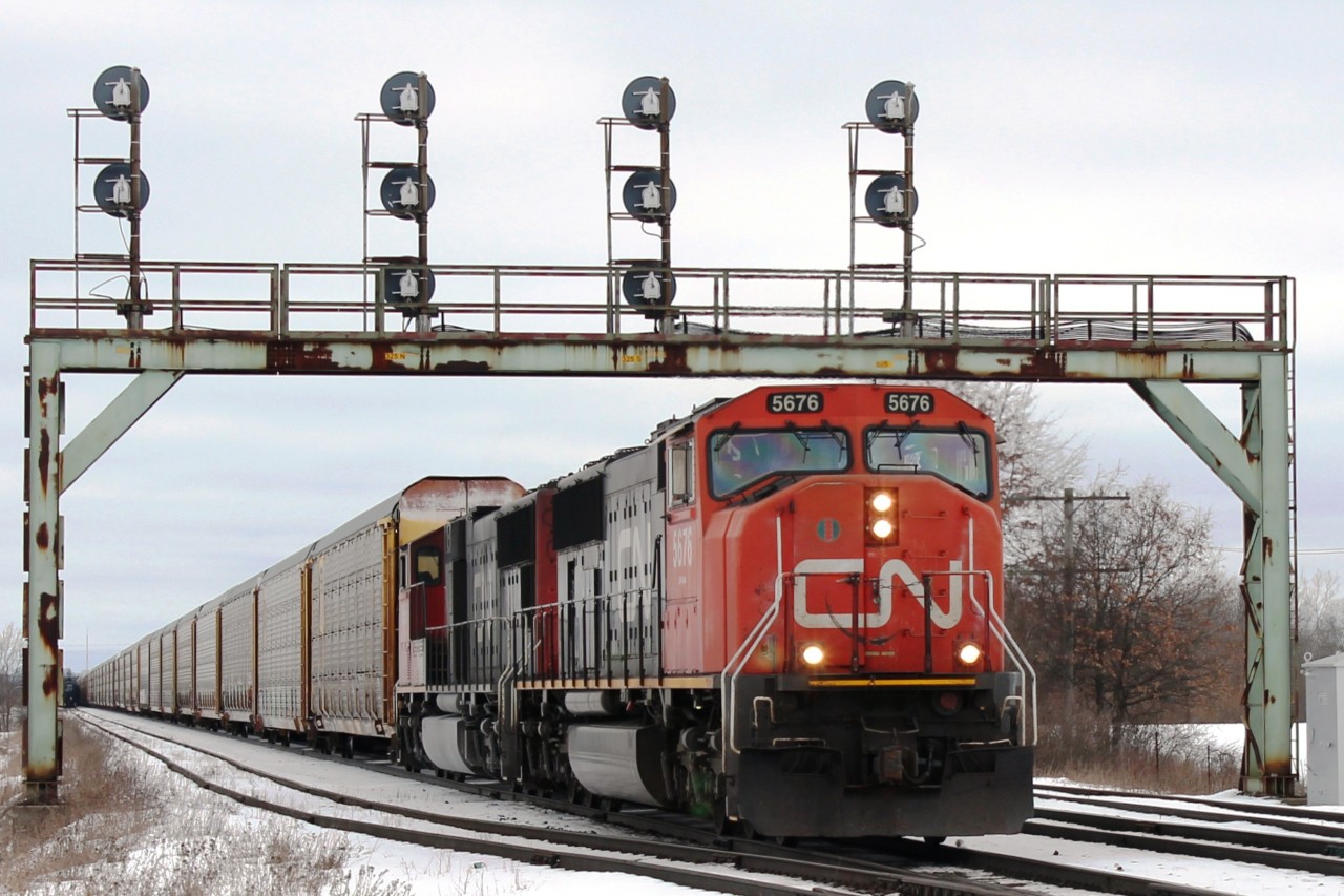 West bound autoracks passes under the distinctive signal gantry at5 Paris West.