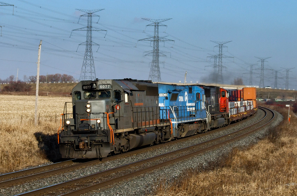 GCFX SD40-3 6077, NS B40-8 4803 and CN SD75I 5779 rocket through Clarke West with daily Halifax-Toronto train Q149.