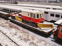 December 1978, T.T.R. North Storage tracks (north of the main, west of Spadina), 
<br>
<br>
On the flat car:  TTC Track Plow # 10 is ready for shipment to Saint-Constant. (Trackside Guide reports unit stored indoors - not on display).
<br>
<br>
( the Trackside Guide records ex TTC  TP-11 (NSC 1945)  at the Halton County Radial Railway).
<br>
<br>
In the background, at the CN Spadina Coach yard:
<br>
<br>
1) Two ( 2 )  Northlander train sets – Werkspoor TEE powered!.
<br>
<br>
2) ex CN Tempo equipment in Via colours – this equipment is now the Algoma Central tour train (formerly D&RGW Ski Train).
<br>
<br>
3) CN 'Car- Go – Rail' box car in CN passenger livery – a regular attachment to the tail end of the daily Super Continental<br>
<br>
<br>
4) Hawker Siddeley built single level GO Transit equipment on the adjacent T.T.R. North Storage tracks.
<br>
<br>
December 1978 Kodachrome by S. Danko
