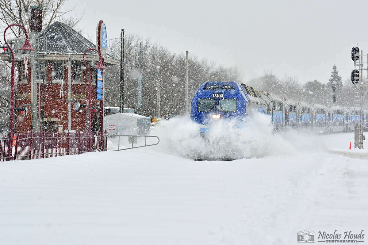 SPLAT! In the snowstorm, the first train of the day on the CP Westmount Subdivision, AMT #60 with an ALP-45DP in lead, smash the snow as it pass Montreal West tower.