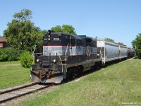 One would hardly think this lush green scene is deep in busy Downtown Brampton, but it is! CCGX 1000 rolls south with the biweekly Orangeville Brampton Railway local, heading from Orangeville to Streetsville to interchange with CP, while switching out the few Brampton customers along the way. Here we see the short train heading south past the former CPR Brampton Station grounds, crossing Nelson St. just north of bustling downtown Queen Street behind us.
<br><br>
We're looking north, standing where the old station and platforms used to be, along with a former passing track and long-demolished express/freight shed for loading cargo on a siding across from the station. The CPR's Brampton Station was built 1902, closed 1969 (railways were discontinuing passenger service on many of their lines during this period due to the private automobile gaining popularity, thus rendering many stations redundant), saved from demolition with lots of effort by the city and its citizens, moved in 1981 to a nursery, later condemned, designated a heritage building, dismantiled and stored on a farmers' property until being rebuilt a few years ago as part of a community centre in the Mount Pleasant Village area. The nearby <a href=http://www.railpictures.ca/?attachment_id=11147><b>CNR Brampton Station</b></a> continues to serve passenger trains of both VIA & GO.
<br><br>
<i><u>For small a tour of the Orangeville Brampton Railway:</u></i><br>
Orangeville Station, home base: <a href=http://www.railpictures.ca/?attachment_id=415><b>http://www.railpictures.ca/?attachment_id=415</b></a><br>
Passing amid the golf courses in Alton: <a href=http://www.railpictures.ca/?attachment_id=9134><b>http://www.railpictures.ca/?attachment_id=9134</b></a><br>
South by Cataract Falls: <a href=http://www.railpictures.ca/?attachment_id=3767><b>http://www.railpictures.ca/?attachment_id=3767</b></a><br>
Crossing the bridge in Ferndale (Caledon): <a href=http://www.railpictures.ca/?attachment_id=3770><b>http://www.railpictures.ca/?attachment_id=3770</b></a><br>
McMurchy Ave, just south of Downtown Brampton: <a href=http://www.railpictures.ca/?attachment_id=8996><b>http://www.railpictures.ca/?attachment_id=8996</b></a><br>
Heading for Mississauga city limits, Chinguacousy Rd: <a href=http://www.railpictures.ca/?attachment_id=3831><b>http://www.railpictures.ca/?attachment_id=3831</b></a><br>
Interchanging cars at Streetsville: <a href=http://www.railpictures.ca/?attachment_id=5178><b>http://www.railpictures.ca/?attachment_id=5178</b></a><br>
Back up north, working the north end of Orangeville: <a href=http://www.railpictures.ca/?attachment_id=12489><b>http://www.railpictures.ca/?attachment_id=12489</b></a>

