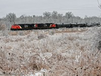 'Ice to see you' - McBain. Dropping down the grade to Liverpool Jct., CN 2227 and 2542 ease 376's train at a greatly reduced speed towards the Ressor Road grade crossing. With the obvious extent of the ice storm that had just passed, and the havoc it reeks on electrical infrastructure, CN can't take for granted that the grade crossing signals are working properly through here. 1119hrs.