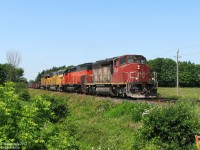 Possibly one of my favourite train consists: beyond the suburban development on a sunny late morning in July of 2008, we find ourselves posed amid the countryside on Mississauga Road for the coming of some Foreign Power goodies.
<br><br>
After VIA #85 rockets by with its usual F40PH + 2 Budds and stops at the Credit for a meet, CN #398 rolls into town with a colourful FPON lashup of epic proportions: a beat-up SD40-2W (CN 5248) leading a rebuilt Bessemer & Lake Erie Tunnel Motor (BLE SD40T-3 909) rarely seen in these parts, and two yellow UP units for good mix (UP SD60M 2401 and SD40-2 2972). The train is still clipping along, but will be slowing shortly for the red track flags and Rule 42 work limits up ahead. Unfortunately, an errant bush obscured a trailing shot of the backwards-facing 909. Eh tu mother nature.
<br><br>
The haul for the afternoon included VIA #85, CN #398, GO #266, CN #393, CN #422, CN #338, and GO #281, but we all know which one took the cake...