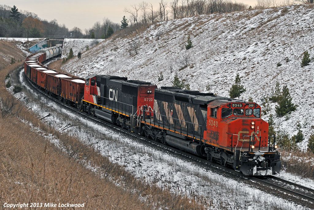 I had two choices on this day; shoot the CP 420 that Michael Delic has posted at Beeton, or go after CN X371 with an SD40-2W leading. Hmmm. Easy choice, X371 was a lot closer to home and I haven't shot an SD40-2W leading in a few years. So I wound up shooting this train at four locations, including one of my favourite haunts, here at Beare, where they're into the ruling grade for westbound freights between Montreal and Toronto. It not a pair of GP9's, but the 5348 and 5723 still sounded great lifting X371 up the hill. 1345hrs.