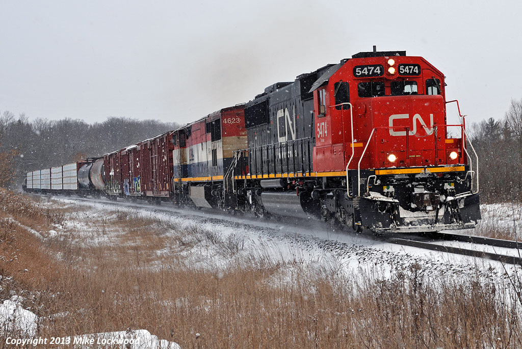Having just met VIA #1 at Zephyr, CN 412 has slowed down in order to avoid having to stop as 301 enters the siding at Pine Orchard ahead. CN 5474 and BCOL 4623 power the first of five southbounds that 301 will meet at Pine Orchard, 412, 112, 114, 302 and 104. At least this very patient crew will get the main at Zephyr for another 114, and a 314 at Pefferlaw. Not sure who got the siding at Brechin East when they met 874. 1110hrs.

I have never seem this much action on the Bala in one day, let alone a short winter's day. In the space of five hours I shot 10 freights (CN 412, 112, 114, 302, 104, 301, a second 114, 314, 874, 107) and one passenger (VIA 1). Must have been some weather related delays up north.