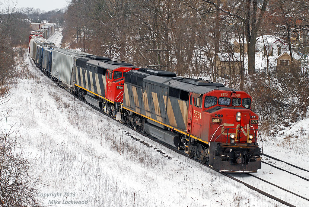 Curving through the approach to the bridge over the Grand River, CN 5561 and 5528 have a good handle on 148's train. The 5444 was also on 148, however they were compelled to hand it off to 393 at Beachville after the trailing unit, 8869, suffered a major failure. The SD60F's are becoming much more common here in the east in the last few months as that have migrated east from the prairies, bumped from secondary assignments by units (I assume) that were in turn bumped out of coal train service by the new ES44AC's. 1447hrs.