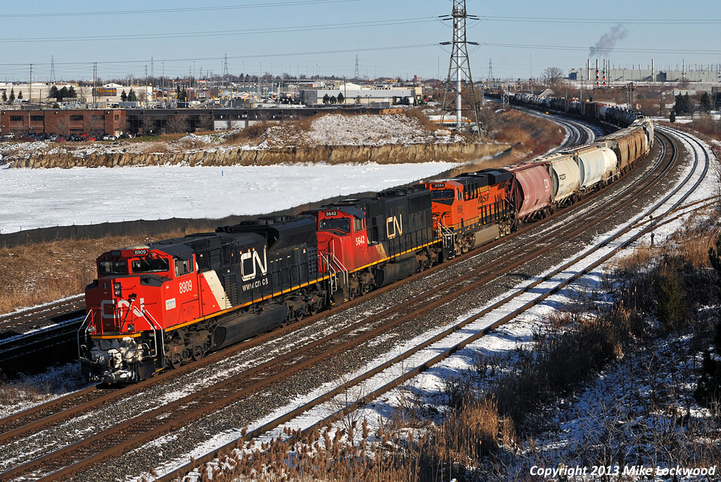 A late running 309 flies through Whitby behind CN 8909, 5642, BNSF 6584, and DPU CN 8954. They must have been trying to make back some time on what is normally nocturnal train through these parts, as the detector about a mile or so west read 61mph. As seems typical in railroading, the BNSF unit is an A-1-A trucked speedster intended for use on the successors to the old ATSF 199/991 trains, so of course it has managed to find it's way onto a CN freight. 1231hrs.