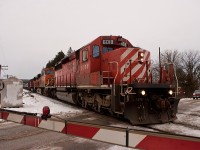 Taking a brief break from my Huron Central shots to put this up. 

Today, I received an email from Bill Miller via the Yahoo FPON group that the BNSFs on this train were still in Toronto yard. About an hour after the shipment tracker reported the third unit as arriving in Obico, I decided to go out to Milton to get a shot of them that wasn't at Lisgar GO - that place hasn't been shot at enough yet! 

Unfortunately after leaving my house and clearing off the car, I heard GM's working their way up the grade by my house, so I decided to hammer it west on the 401 to get a shot featuring the farm bridge in Campbellville. While I made it there on time, seconds before I was going to go across, an eastbound solo AC44 powermove rolled through.

The gates stayed down, and this train was quickly approaching, so I just resorted to a gate shot.

I tried to chase this to somewhere in the area west of Guelph Junction, but after slowly passing me they highballed it up to 60 in no time, and when I could finally see them again, they were going faster than me! I decided to then head for home.