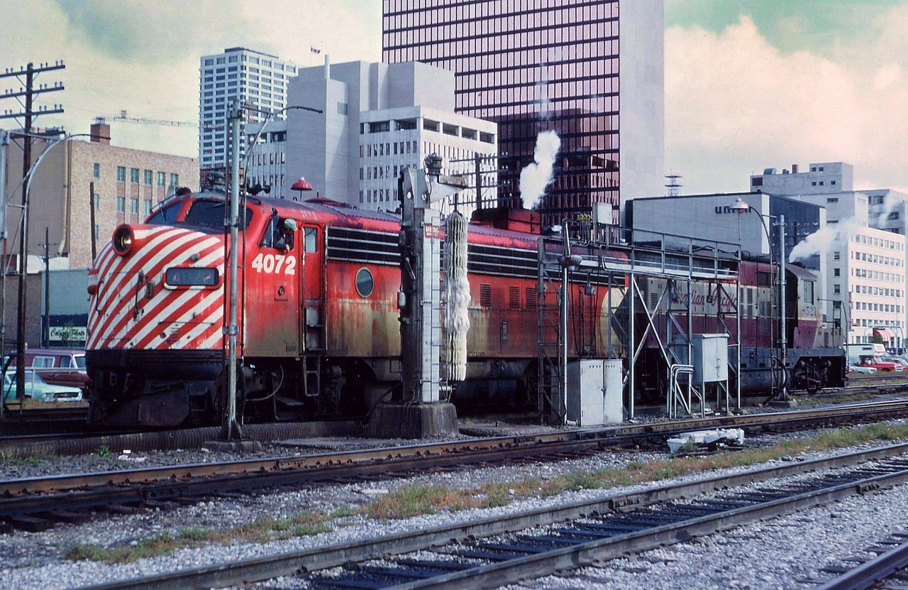 On a day wherein the sun wasn't quite as strong as the dirt, it appears CP 4072 and 8521 are lining up at the "train wash" to get a cleaning up. I wondered if this was power for a Transcon passenger but I did not see any train around. Last I knew of 4072, she was 1303 on AMT in Montreal. CTG states the unit then went to a tourist road in 2002. The 8521 was rebuilt to 1538 and retired in 2012.