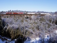 A late running 133 crawls over Cherrywood, preparing for a meet with train 608. The sights in this area are quite spectacular due to the ice storm.