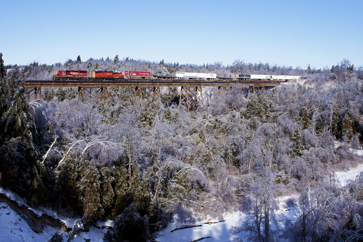 A late running 133 crawls over Cherrywood, preparing for a meet with train 608. The sights in this area are quite spectacular due to the ice storm.