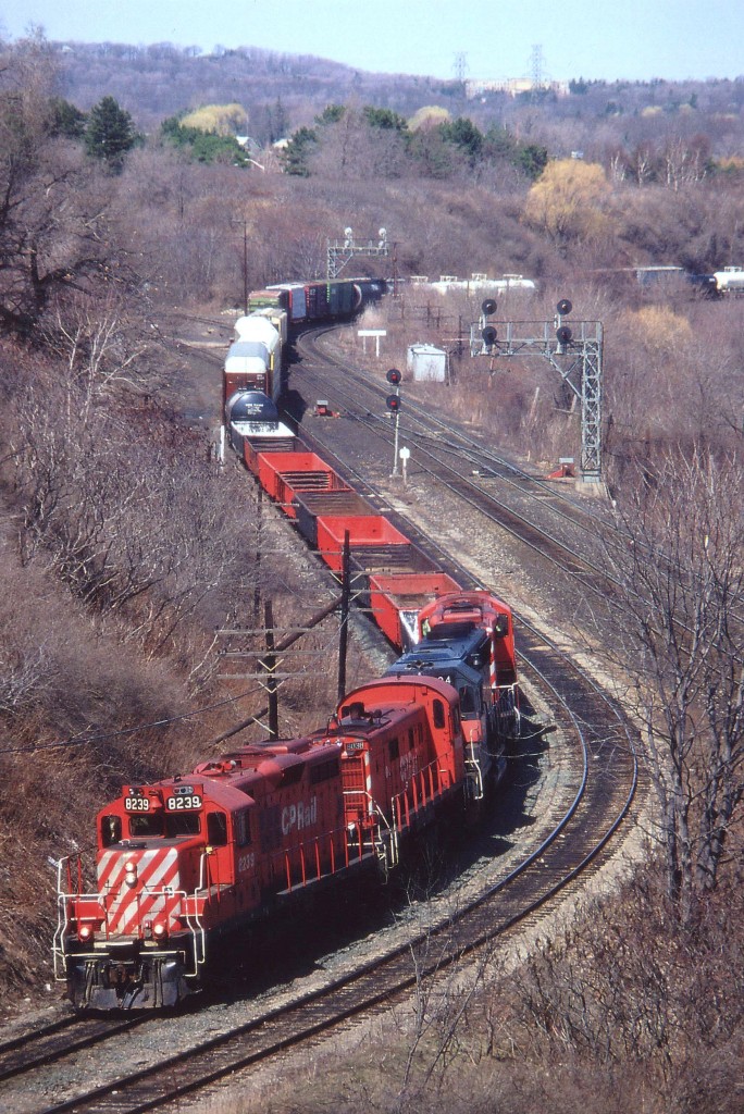 Another one of those beautiful spring days for train watching. CP 8239, 8038,HATX 504 and CP 8231 are seen about to duck under the High Level bridge with a 500-series local from Toronto. For those not familiar with this area, the train has just come off CN thru Hamilton Jct and  to the right just out of sight the tail end of the train is rolling thru CN Bayview Jct. The CN double track on the right goes to Niagara. Second unit, an RS-23, was dealt off to Windsor & Hantsport RR of Nova Scotia not long after this photo was taken.