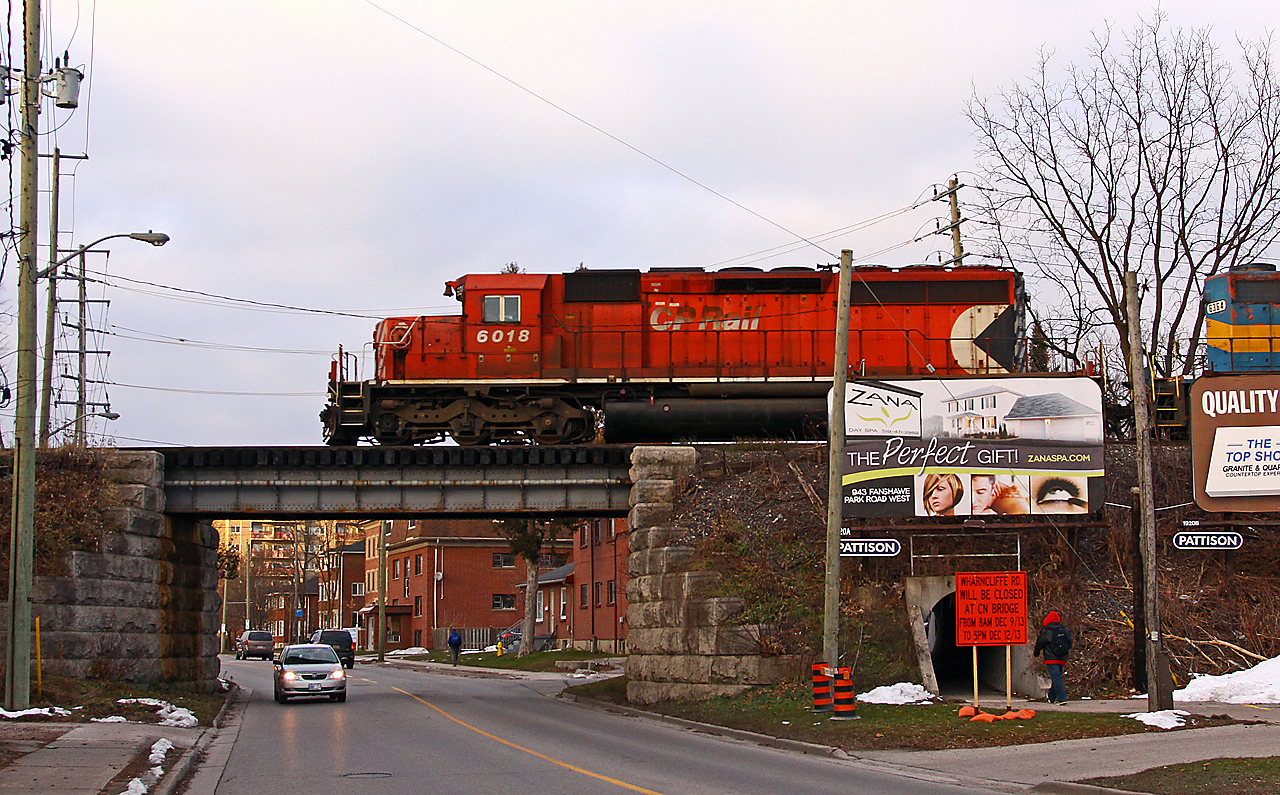 The second of three westbounds in short succession, CP 147 speeds out of town and up the grade to Lobo. This was the first time in a couple of months I'd seen an SD40-2 in the lead, and overall it was a pretty neat consist: CP 6018-DME 6364-CSX 7519-8055. Wharncliffe road under the bridge will be closed for a couple days next week for track maintenance/inspection, but can anyone spot the obvious flaw with the road sign?