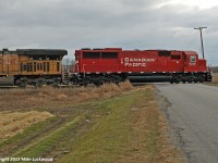 CP 6256 hits the crossing of Maple Grove Road as it leads UP 6937 and 241's train west at Bowmanville, Ontario. 1412hrs.