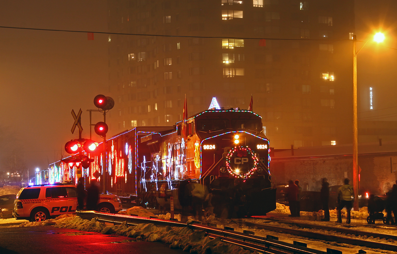An unusually foggy December night seems to have thinned out the crowds as CP's US Holiday Train makes its' annual London stop at St. George street. The consist is such that when the performance (stage) car is stopped over Richmond street (closed to vehicular traffic for the event), the engine is positioned right at the begin/end CTC London.