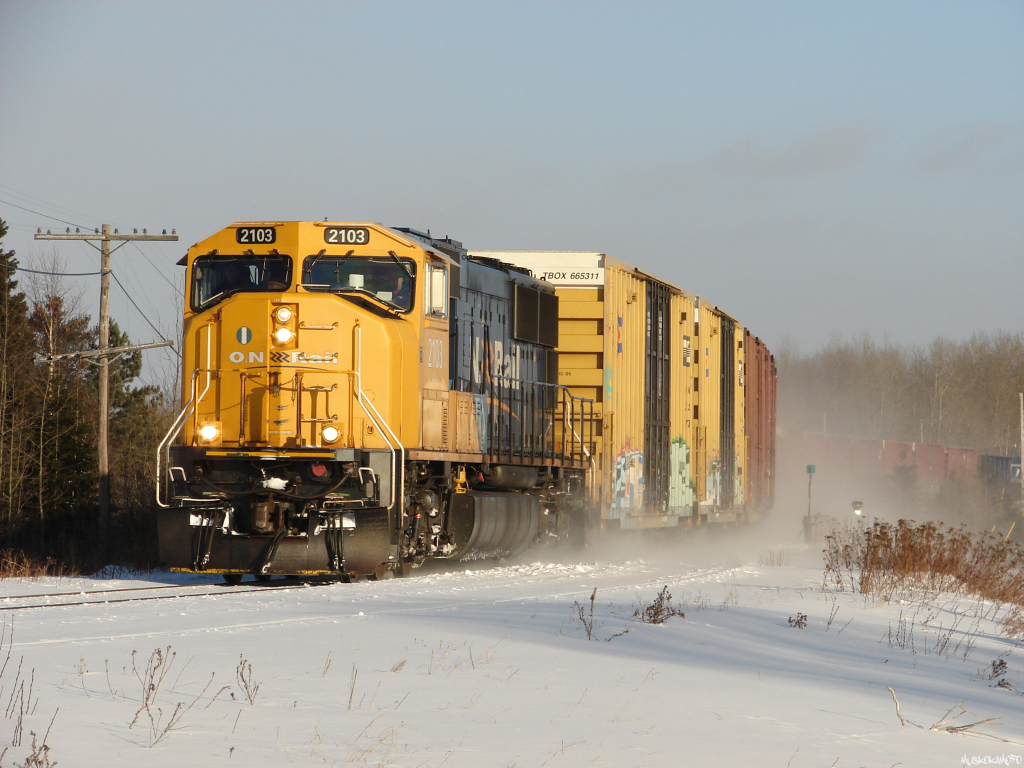 ONT 2103 North with train 213-11 from Englehart to Cochrane, with work at Iroquois Falls, highballs through downtown Matheson in some perfect afternoon lighting!