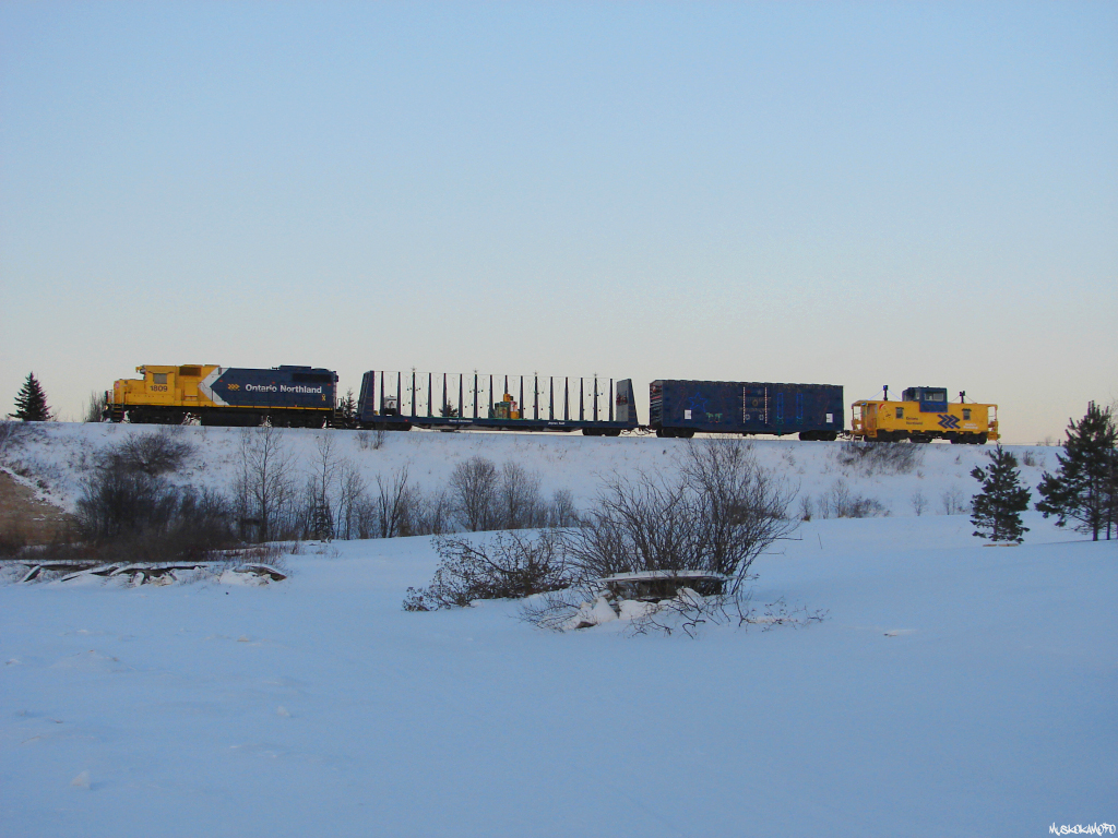 ONT 1809 "North" with ONR's Christmas train heads West about to cross the bridge spanning the frozen Groundhog River, making for a bitterly cold, but different angle for yours truly!
