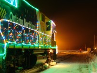 Ontario Northland's "Christmas Train" making it's scheduled stop and stay at Kapuskasing on a crisp -32 night in Northern Ontario. Some locals get their pictures from the crossing as trucks flow in/out of the mill, despite the tripped automatic warning devices.
