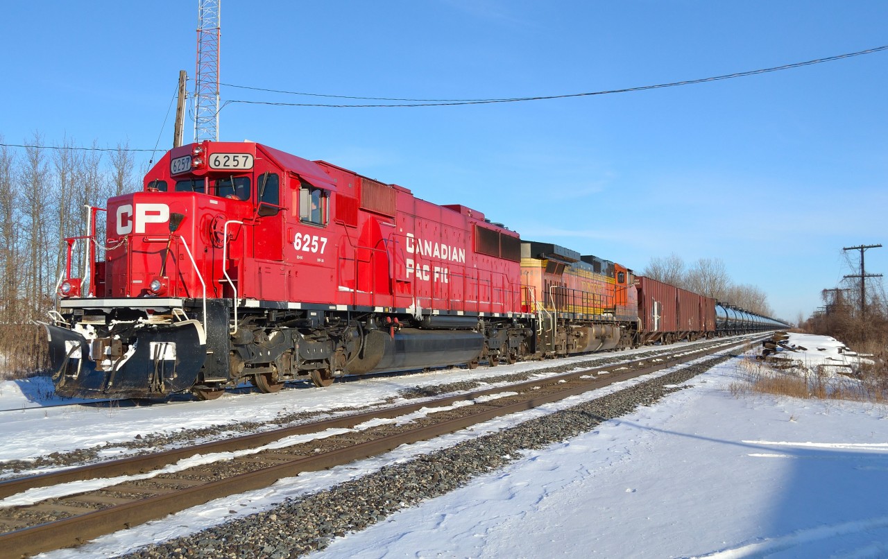 A welcome sight becoming more common lately. CP 609 with CP 6257 & BNSF 4442, waits in the siding at Belle River for a couple eastbounds to pass by.