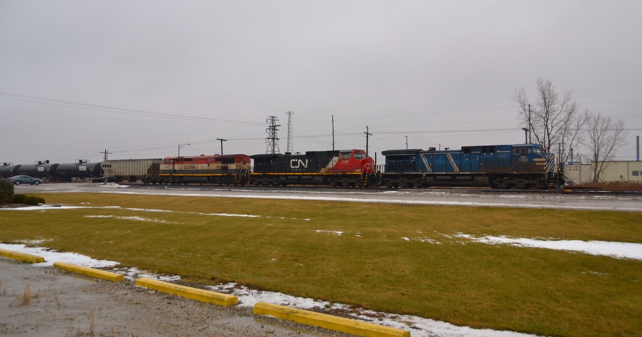 Providing a little variety of colour on an otherwise gloomy rainy day, CP 641 led by CEFX 1052-CN 2597-BCOL 4622 heads westbound towards Windsor as it passes thru Tilbury.