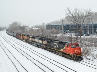 <b>Ex-ATSF, ex-BN & BNSF.</b>A great lashup of CN 2098, BNSF 9661 and BNSF 5092 leads loaded oil train CN 710 through Montreal before stopping for a crew change at Turcot West. All three engines were owned by BNSF at one point, CN 2098 was originally ATSF 865, then BNSF 865. BNSF 9661 began life as BN 9661 and is still in its original paint scheme, though BNSF stencilling has been added. The third engine was built for BNSF in 2004. For more train photos, check out http://www.flickr.com/photos/mtlwestrailfan/ 