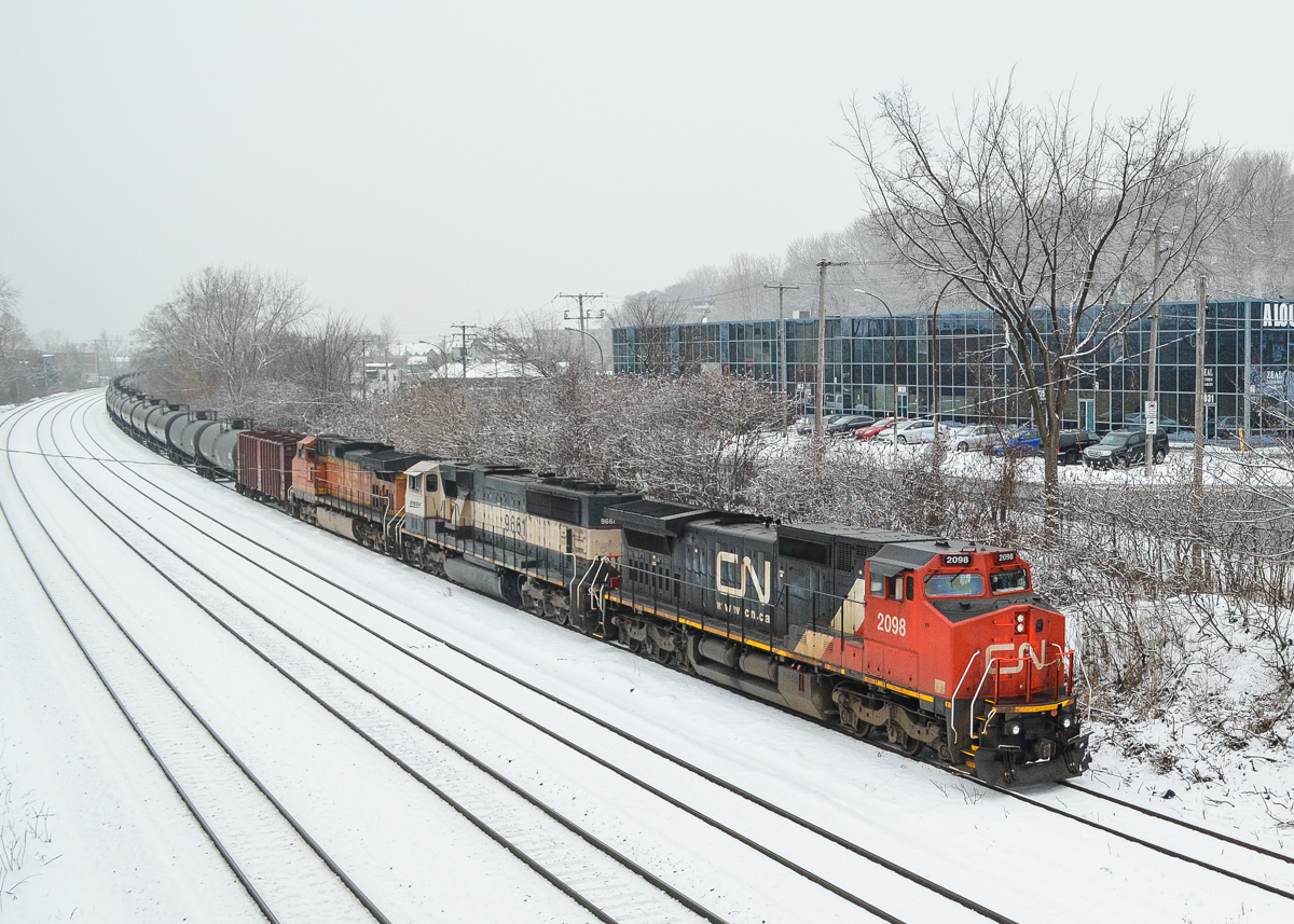 Ex-ATSF, ex-BN & BNSF.A great lashup of CN 2098, BNSF 9661 and BNSF 5092 leads loaded oil train CN 710 through Montreal before stopping for a crew change at Turcot West. All three engines were owned by BNSF at one point, CN 2098 was originally ATSF 865, then BNSF 865. BNSF 9661 began life as BN 9661 and is still in its original paint scheme, though BNSF stencilling has been added. The third engine was built for BNSF in 2004. For more train photos, check out http://www.flickr.com/photos/mtlwestrailfan/