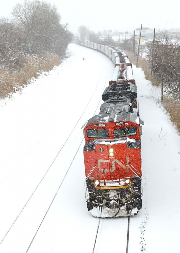 Though you can't tell from this shot, this is actually an empty unit oil train (CN 711). CN put about 30 cars of manifest freight on the head end. Solo power is CN 8918, heading west as the snow falls after a crew change at Turcot West. For more train photos, check out http://www.flickr.com/photos/mtlwestrailfan/