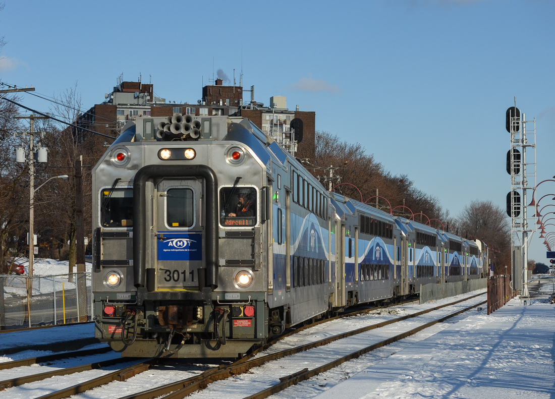 Cab car AMT 3011 is leading AMT 15 westbound through the crossovers at Montreal West on a sunny and cold day. Pushing on the rear is AMT 1321 (GMD F59PHI. For more train photos, check out http://www.flickr.com/photos/mtlwestrailfan/