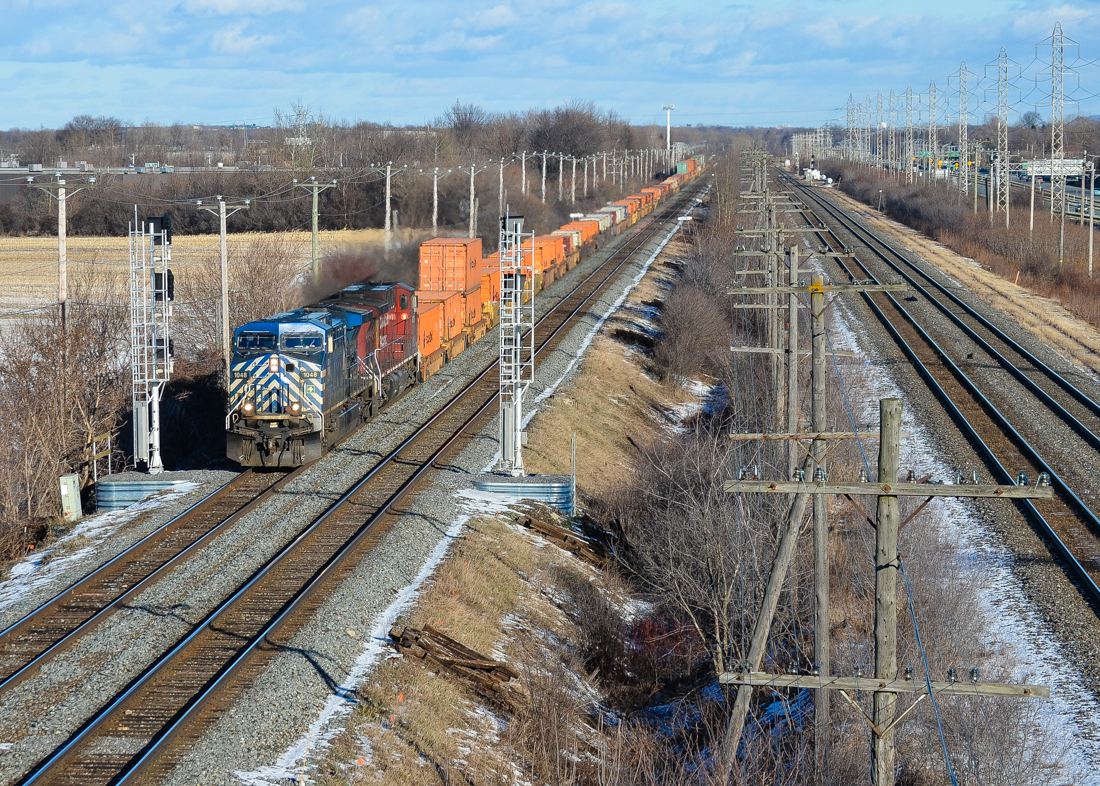 At the very western tip of the island of Montreal we see CEFX 1048 & CP 9729 heading west with a stack train and passing a new set of signals which have yet to be activated. To the right is CN's Kingston Sub. For more train photos, check out http://www.flickr.com/photos/mtlwestrailfan/
