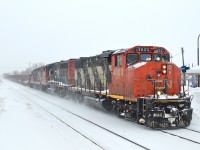 <b>A broom and a shovel.....</b>Are two key implements for Canadian railroaders. Both are seen on the nose of CN 4803, leading two other geeps (CN 9418 & CN 7015) as they head east through Dorval with a short local. For more train photos, check out http://www.flickr.com/photos/mtlwestrailfan/ 