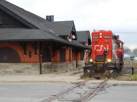 CN 4022 has finished switching Ingenia and has returned downtown to run around four cars intended for delivery to SC Johnson. On their trip west along the old LE&N, the rails would spread under the fourth car causing it to derail, thus only 3 cars made it to SC Johnson that day. That awful looking railway crossing eventually got rebuilt, and a few years after that SC Johnson stopped shipping by rail and the line now lies dormant. The old TH&B station in the picture was a popular restaurant for years until the building was gutted by fire. The station was rebuilt and is now a very shady looking night club.  