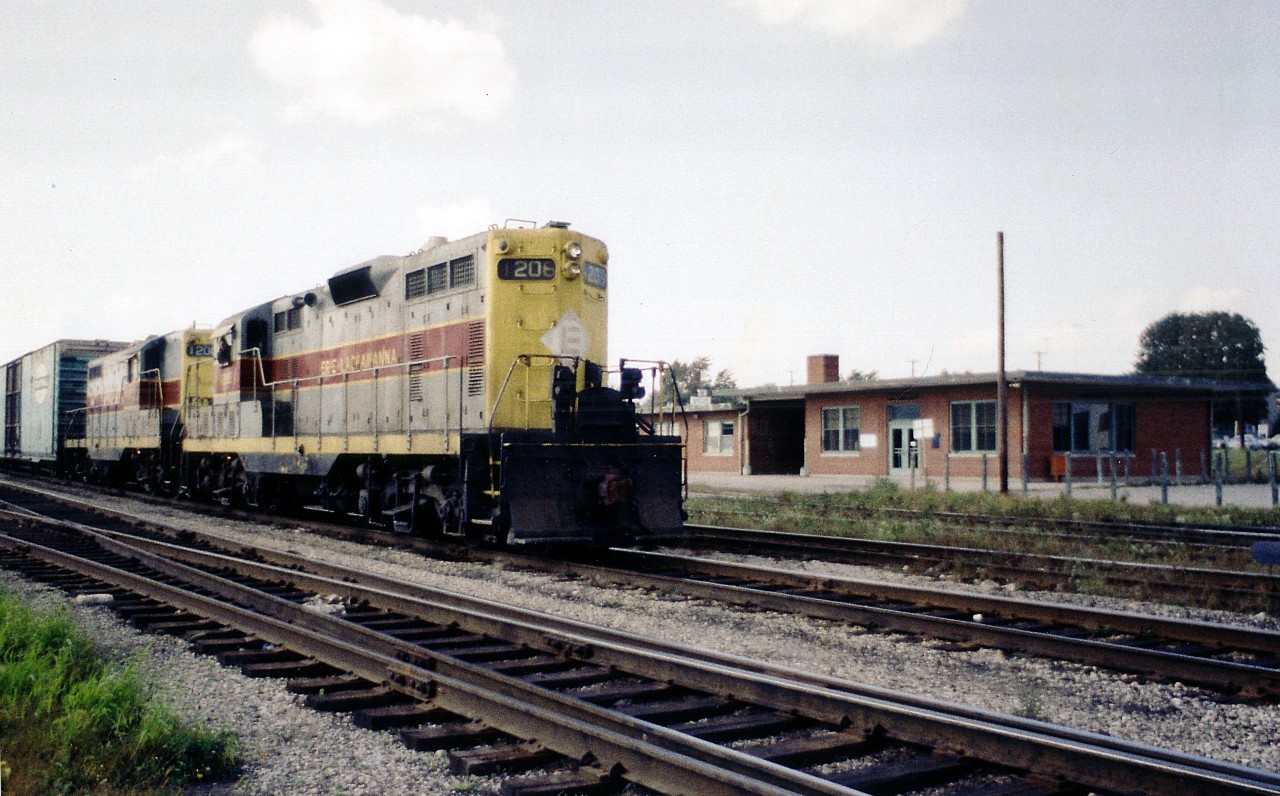 Conrail has come and gone. Erie Lackawanna became part of Conrail the same year this photo was taken, 1976. This was the last time I ever saw any power marked EL enter Canada down at Fort Erie; and, although the image presented here is certainly not of best quality, it is historical non-the-less.
The EL 1206 and 1200 are shown heading back to the States after visiting the sprawling Fort Erie CN yard. Extreme left one can see Central Av bridge and on the right, the modern replacement for the old Michigan Central station that was on the opposite side of the tracks here. This flat roofed structure has since been demolished, somewhere around 25 years ago. It had became expendable  after the last run of any passenger train, the CP/TH&B Budds in 1981.