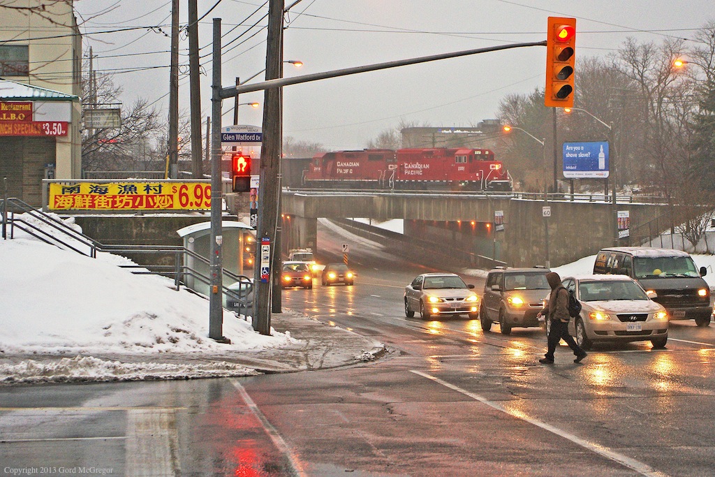 A former Havelock unit 3114 and new 2251 bound for Streetsville as T12 depart Toronto Yard,as commuters go about their business in Sheppard west village.