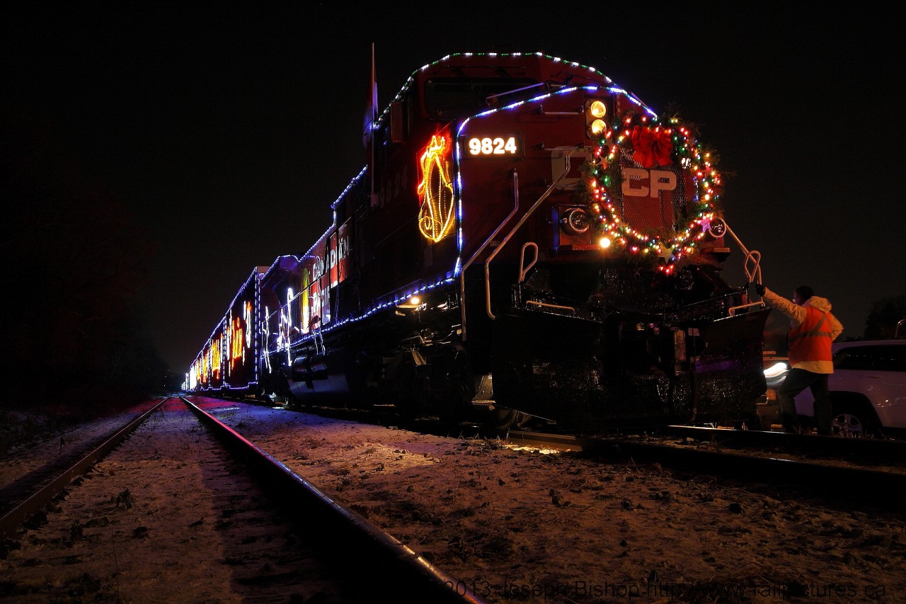 The Canadian Pacific Holiday Train sits at Kinnear Yard in Hamilton Ontario on a nice and cold night.  Most people have stopped walking around the train and the conductor is getting ready to get on and take the train back to Aberdeen yard for the night.