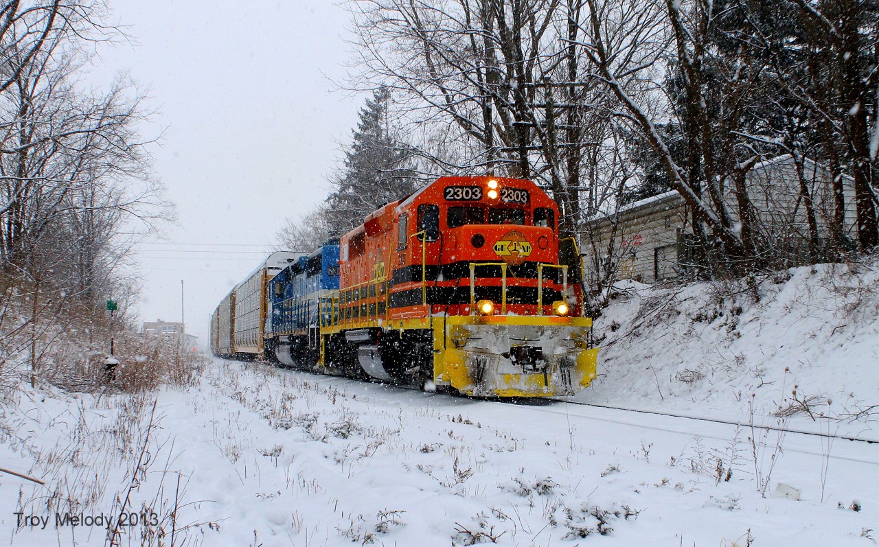 GEXR 432 lead by a newly painted SD40-2 locomotive 7362, renumbered 3202, crosses the Edinburgh railway crossing with a slow order through Guelph (Mile 52 - 48 Guelph sub.) The crossover here that would connect both the south and north tracks together has been some what dismantled. The frogs on the south track have been removed. However, talks between the City of Waterloo, Kitchener, Cambridge, Guelph and GO transit for increased, 2 way all day service. It is quite possible that the south track through Guelph will be revitalized, and a double track system will be built to Kitchener, and out to towards Acton.
