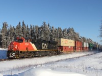 Waiting for some track time... No problem, take in some sunlight, and set up for a nice photo. CN's daily Toronto to Calgary speed, 115 crosses Seagram Rd at mile 92.6 of the Caramat Sub with 92 platforms. CN 8907 is in DP on the rear.

My second last CN train for 2013 (other being a bonus A43641 30 in Thunder Bay, ON on December 30th) and wraps up another great year with my career at CN as a machine operator. 

Happy New Years & All the best in 2014... Keeper on the rails!!!