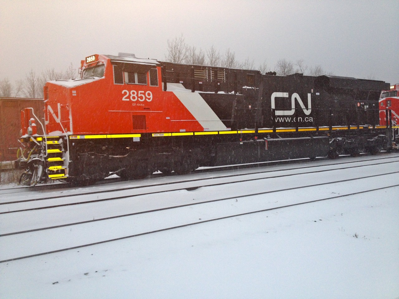Brand spanking new CN ES44AC's 2859,2862,2861 being delivered by NS train 369 at Ft. Erie Ont in the middle of the first snowstorm of the season. These units will be lifted for Mac Yard by train 422 on Dec 15.