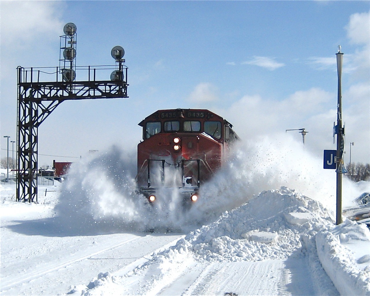 I was at the VIA Dorval Station on a crisp and clear Sunday morning the day after a massive snowstorm. Evidently a train had not passed on this track for sometime, and the lead engine (a now retired SD50F, CN 5435) left me absolutely covered in snow as it passed. Don't ask me what the trailing unit(s) were! For more train photos, check out http://www.flickr.com/photos/mtlwestrailfan/