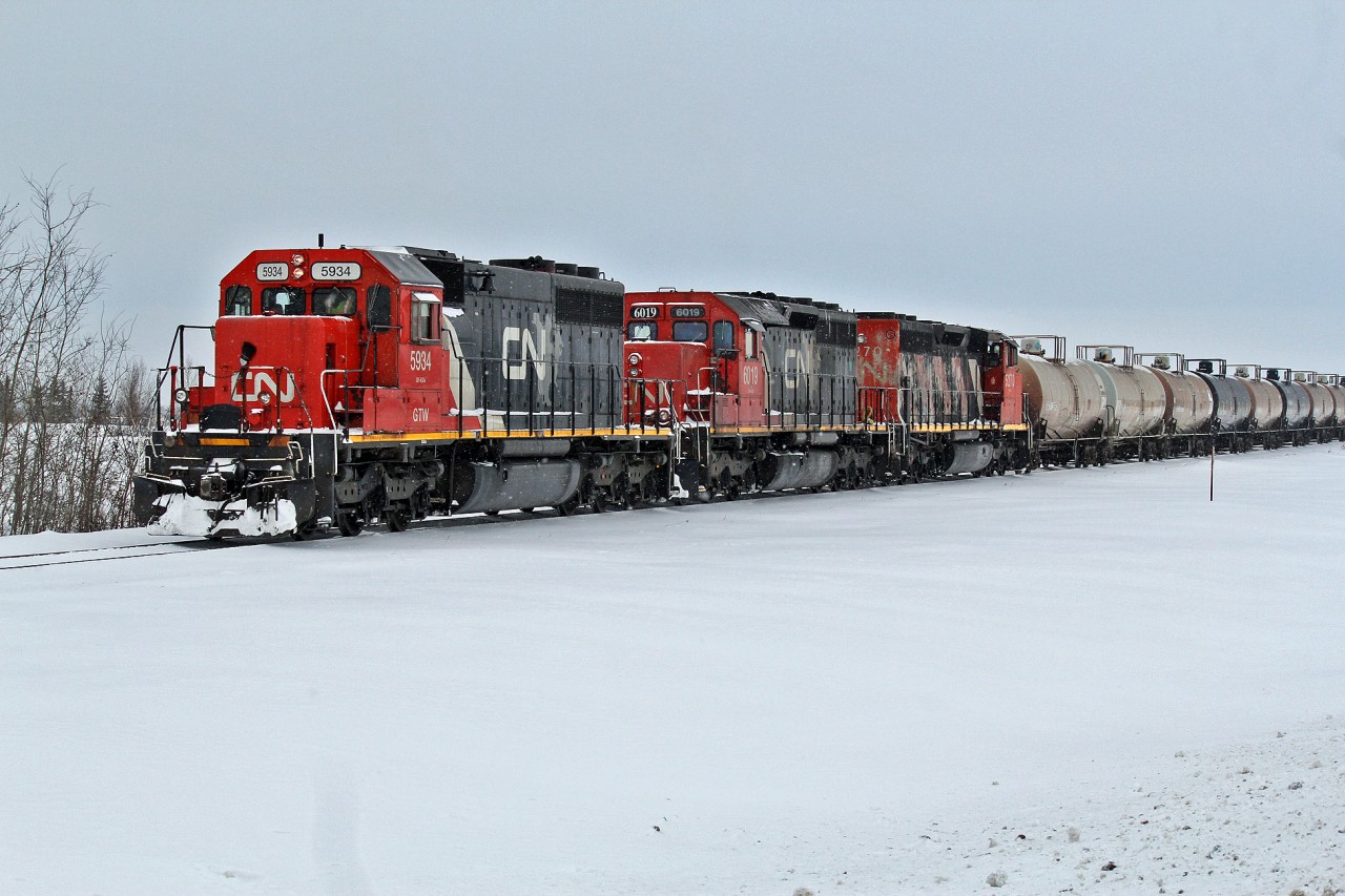 On a cold (-19C)and snowy winter day a trio of SD40's take a cut of tank cars from CN's Scotford Yard along the Fort Saskatchewan Industrial Lead.  The lead locomotive is ex GTW SD40-2 #5934, followed by SD40u 6019 and SD40-2(W) 5270.