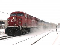 Four locos battle through the snow at the east end of Woodstock yard with a highballing westbound.