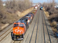 A westbound led by CN 2292, BCOL 4620, CN 7229 and CN 213 cools its heels as a westbound VIA train led by VIA 917 approaches. CN 2292 was only a couple of months old at this time. For more train photos, check out http://www.flickr.com/photos/mtlwestrailfan/