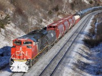 CN 8921 roars around the bend with snow on the plow, bringing a nice mixed freight consist towards Macmillan yard.