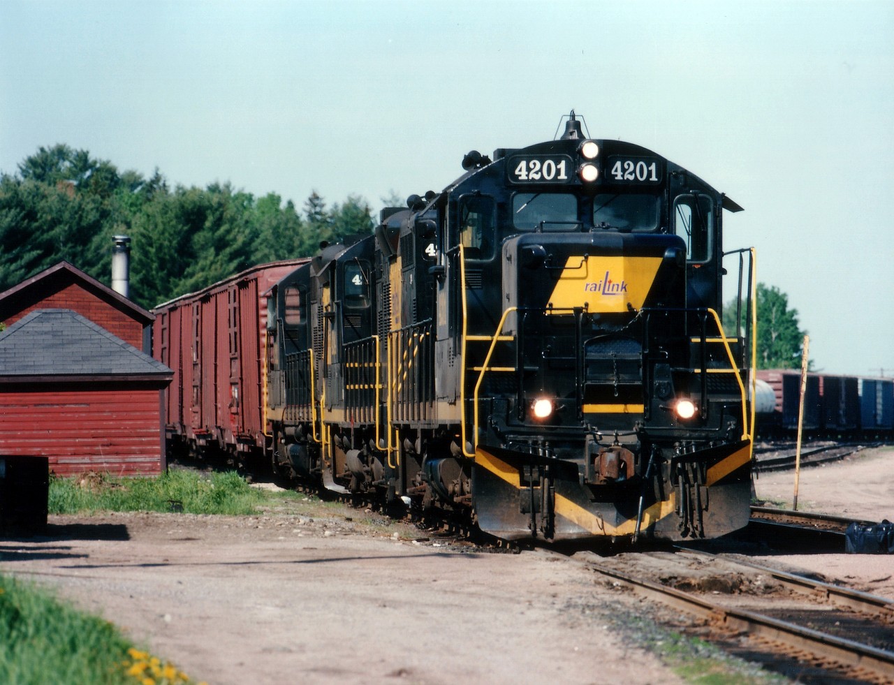 RaiLink 4201 leads sisters 4204 and 4202 on the daily run from North Bay to Temiscaming and return during their days operating on the Ottawa Valley. Just off to the left out of the photo is the CP Mattawa station, which faces the CP mainline. Of the three GP9Es, the 4204 is listed by CTG as 'retired'.  The others ??