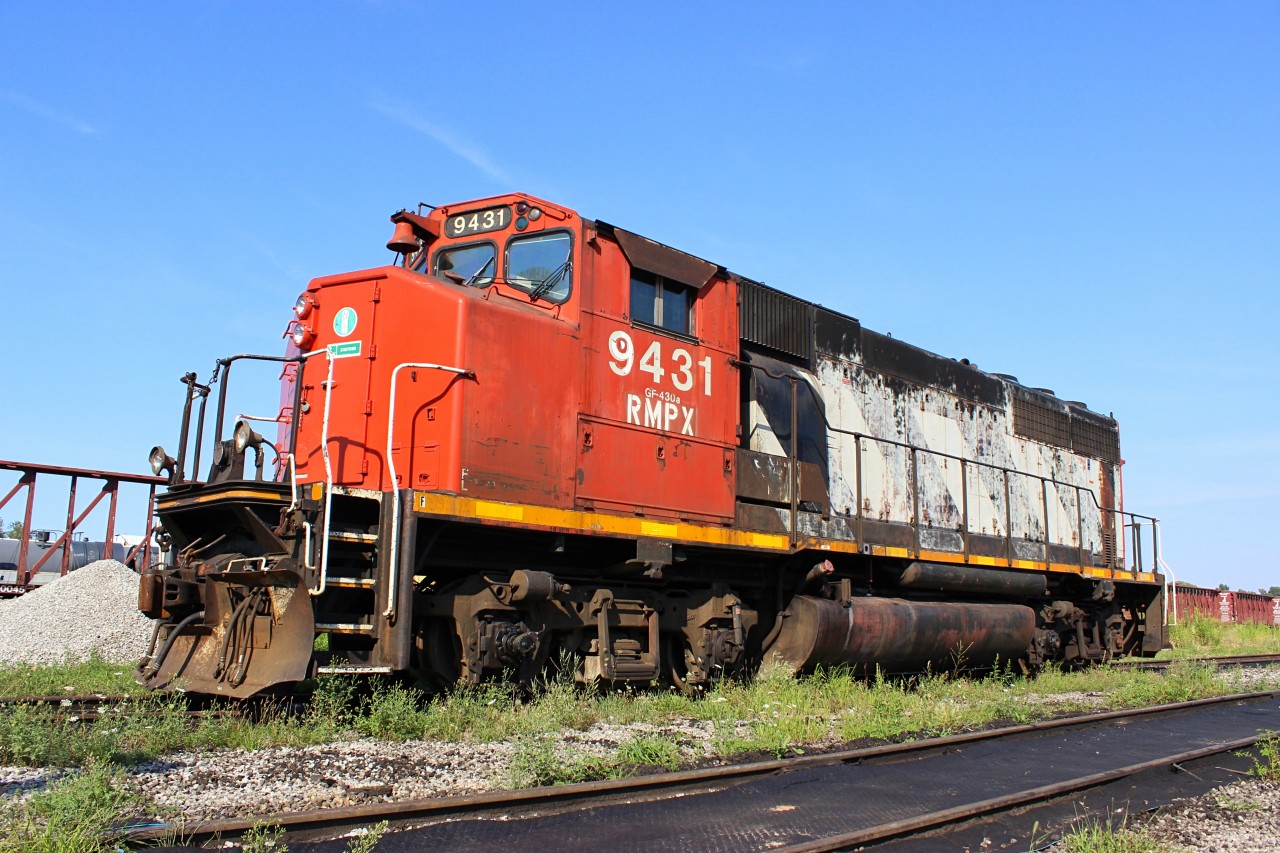 On a warm, summer day, RMPX 9431 sits on the overhaul facility tracks at Hamilton Yard.