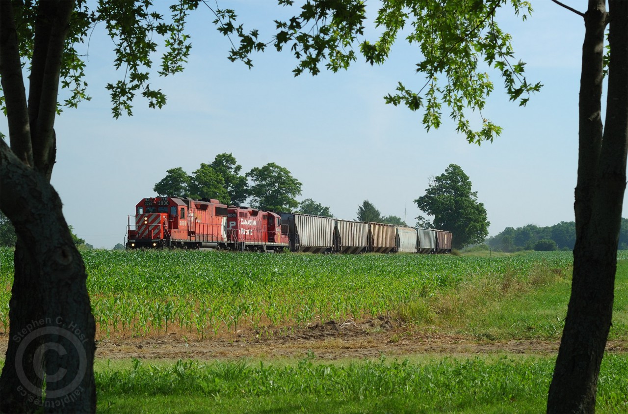 Before OSR CP Transfer woodstocK #21 (TK21) is rolling through the growing corn fields at Putnam, Ontario with 7 loads for the elevator in town. After working Putnam, they ran light power to Ingersoll to lift the OSR Interchange. The St. Thomas sub was a busy place in these days, with up to 8 movements a day. Often you could find CP 141 (Oshawa to St. Thomas) the "Frame Train" meeting a CAMI job at Beachville with item 4's on each other. About three times a week a job would work to Putnam and St. Thomas as required, since the Frame Train was dedicated to General Motors traffic only.