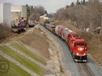 I am standing about where "CNR Finnegan" sign once stood - CP Wolverton-Hagey turn TK22 has arrived into the non OCS CPR Waterloo sub. Based on the outgoing traffic seen they seem to have ran the entire Waterloo sub (Kitchener turn) - scrap loads from Triple Metal , interchange cars from GEXR and loaded Toyota Autoracks from Hagey. 25+ years ago two mainlines ran through this spot - CNR at right (see far back - it's still there, crossover is the end of leased CNR/GEXR Fergus spur) and Grand River Railway at left. Recent construction of this underpass has made this vantage possible.<br><br>At left is the Babcock and Wilcox plant and their spur - you can make out their Caboose and some ancient (riveted construction) cars used for in-plant switching (It is believed some of these flatcars are old Steam engine Tenders). This the same facility that large dimensionals were shipped out of and documented fall 2013 (Search Babcock Wilcox)  by fellow rp.ca photographers.