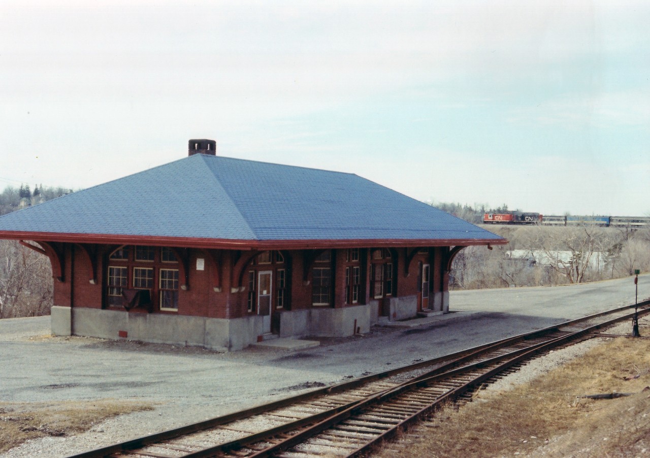 While looking for a proper angle to shoot this old railraod station, I heard an approaching train. Westbound comes the mid-day CN Tempo Train (for this is pre-VIA) and it gave the image a 'little extra', which is why I decided to share it.  The station is the on the line of the former Lake Erie & Northern (aka:Late Every Night) and this was once an electified line. CP, which had taken over the Galt to Port Dover trackage, ran way-freights as needed up until the early 1980s, when the line was shut down and all the trackage pulled up. This station saw the last passenger trains in 1955, and when I first visited here I recall perhaps Ontario Power or some other utility had an office here.  The station was demolished around 1989. Behind the roofline, out of sight, is the huge trestle over the Grand River.
