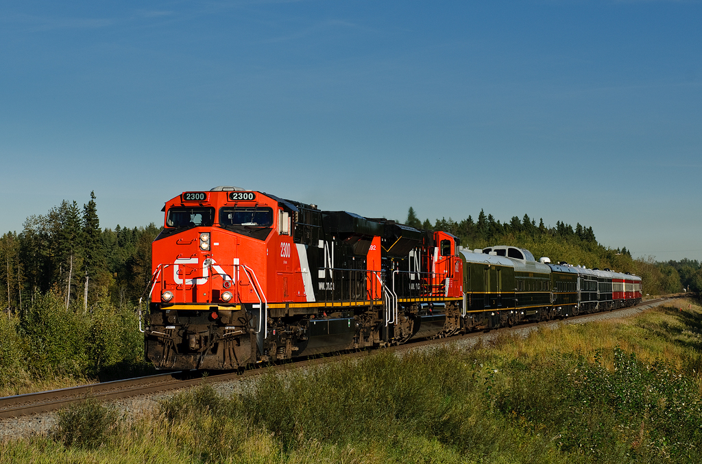 CN ES44DC 2300 and CN SD70M-2 8892 approach the east switch at Gainford, AB with a Board of Directors special. Behind the power was BCOL generator 1710, CN 99, CN 100, IC 800413, IC 800210, CN 1058, CN 1059 and CN 1060.