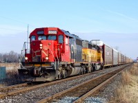 CN SD40-2 5365 and UP SD40-2 3331 bang across the CP Windsor Sub at Melrose with train E27131 04 hauling autoracks from Oshawa, ON to the UP at Salem, IL.